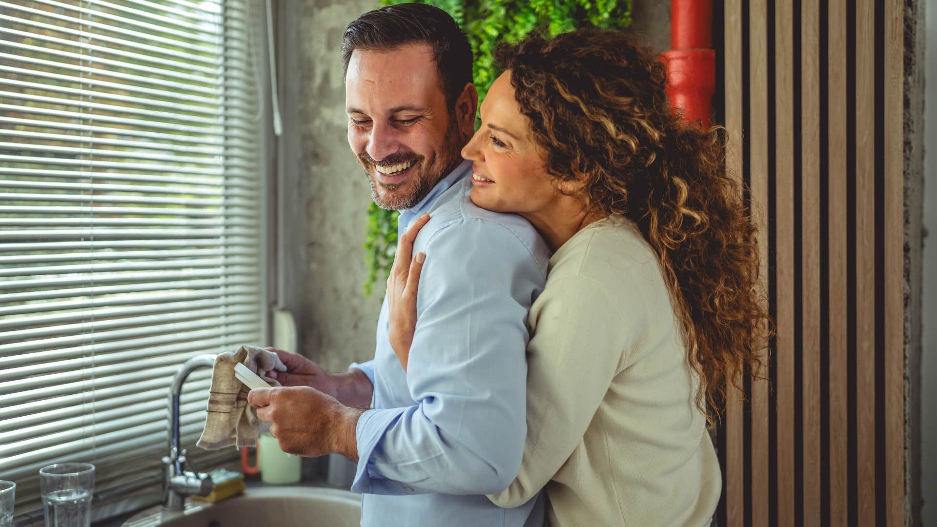 woman hugging man from behind understanding each other without words