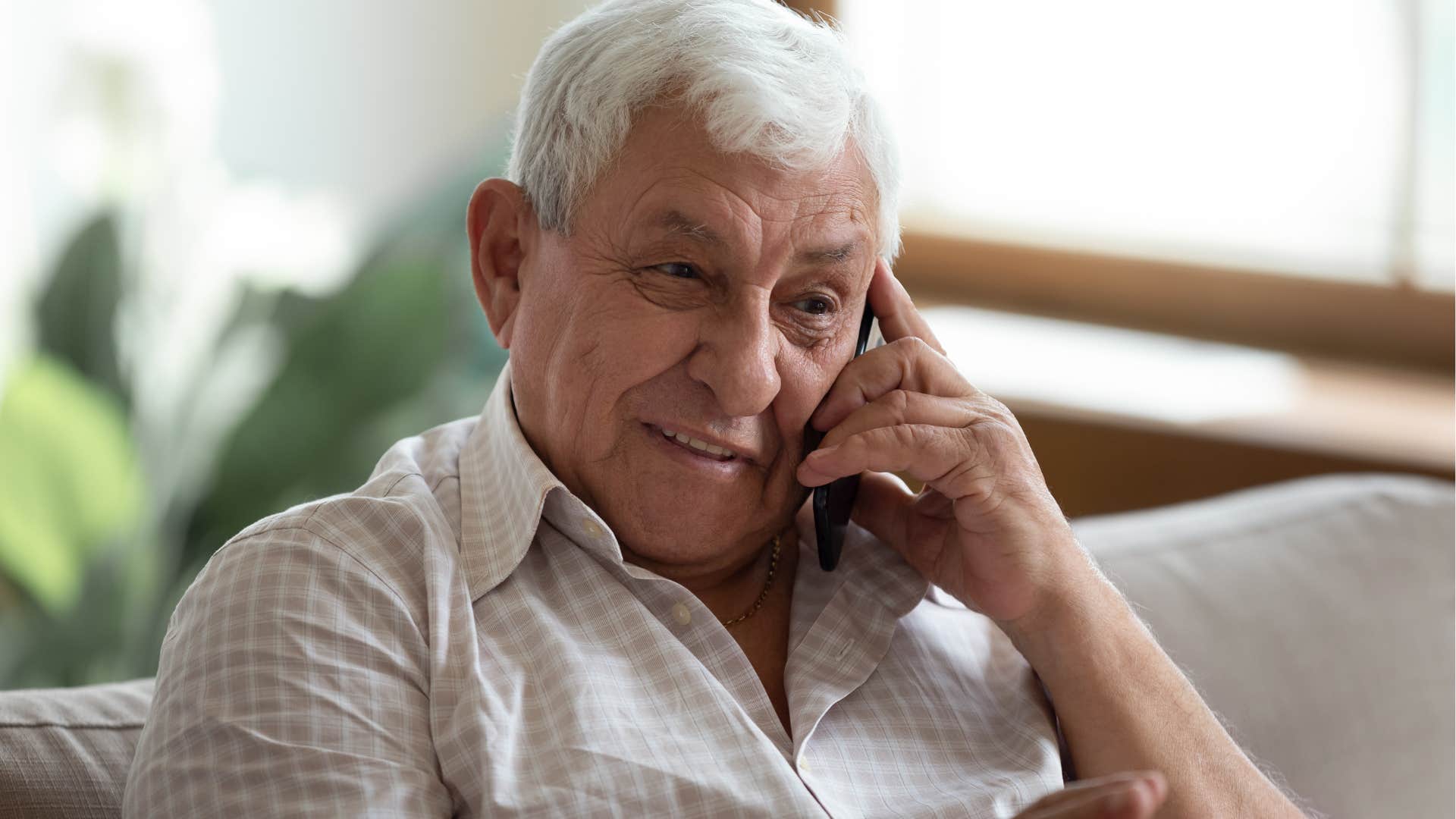 Man who downplays their own struggles talking on the phone.