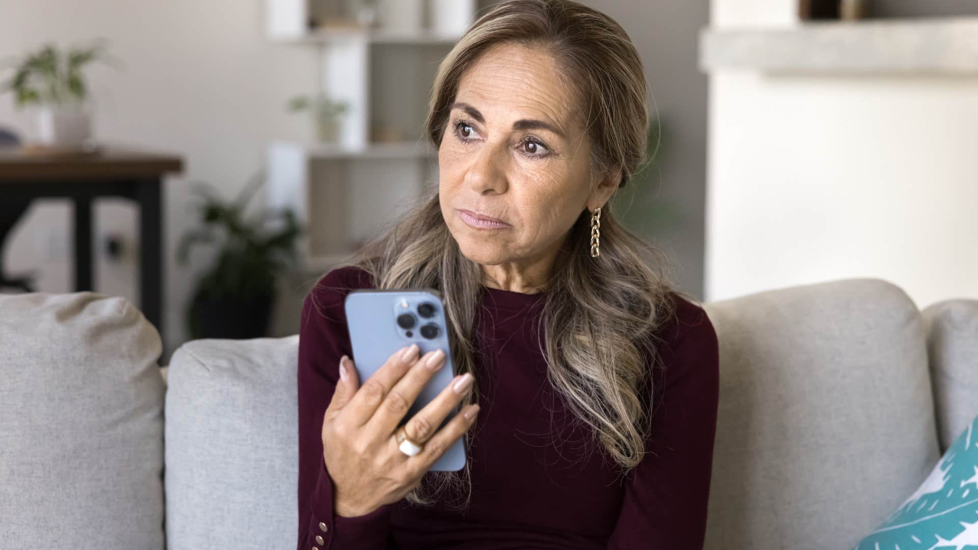 Woman having a gut feeling that something's wrong looking at her phone.