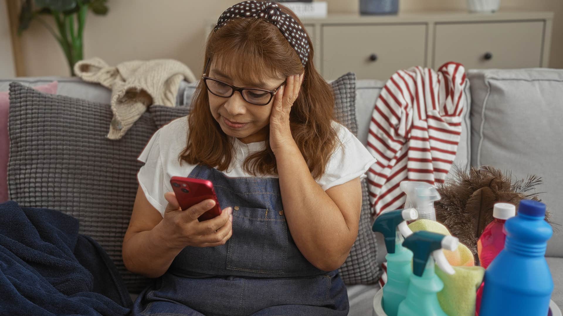 Woman sitting in a living space that feels chaotic at home.