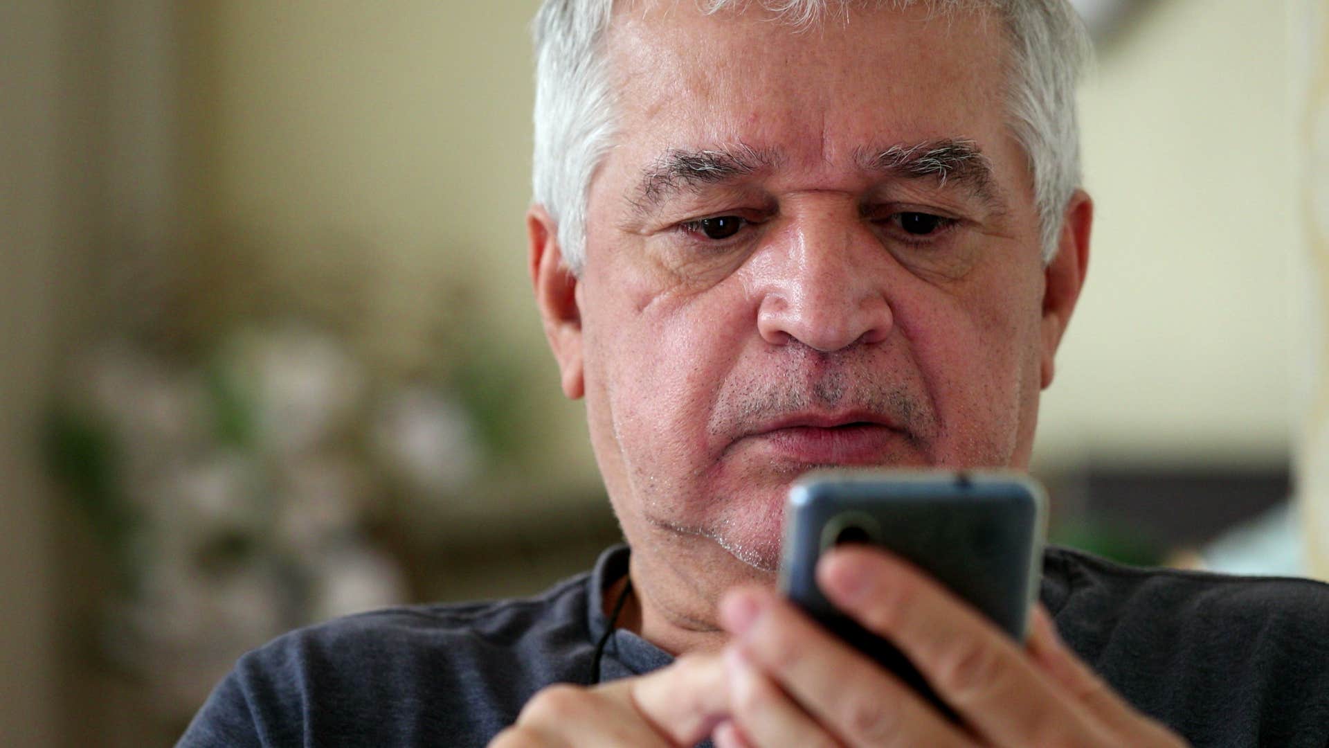 Man who's started missing appointments and obligations looking at his phone.