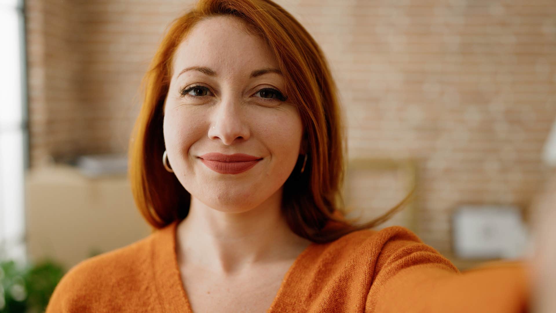 happy woman who's at peace after no longer trying to prove her worth