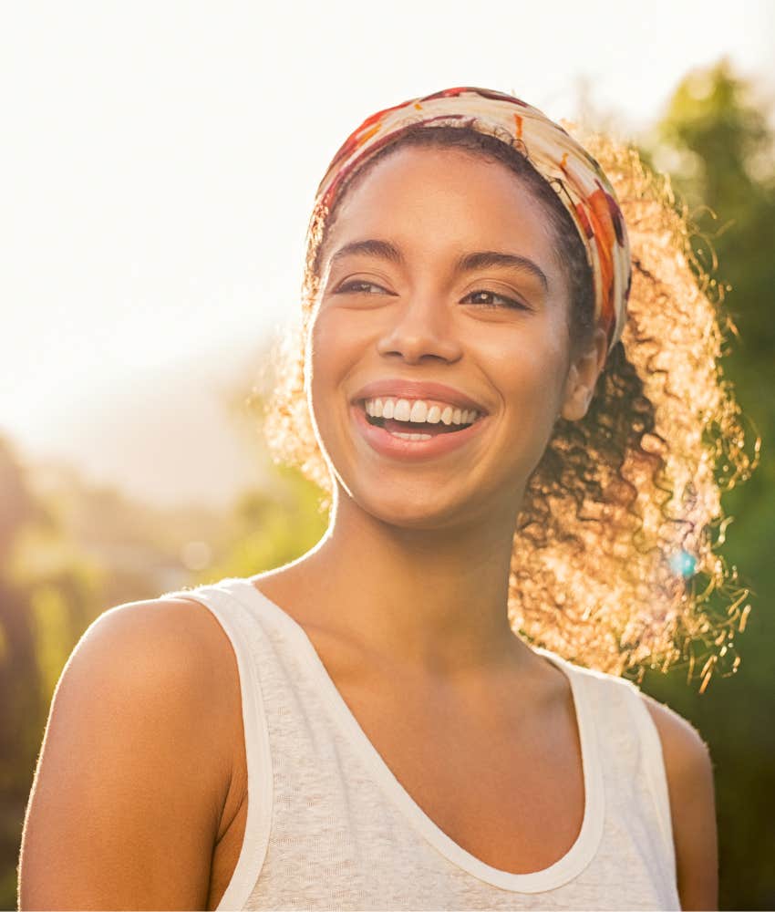 happy person in sunlight showing connection with nature