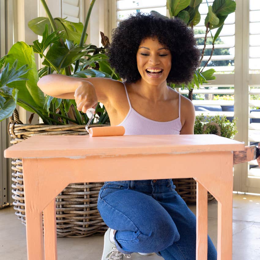 woman saving money using diy techniques to upgrade her furniture painting