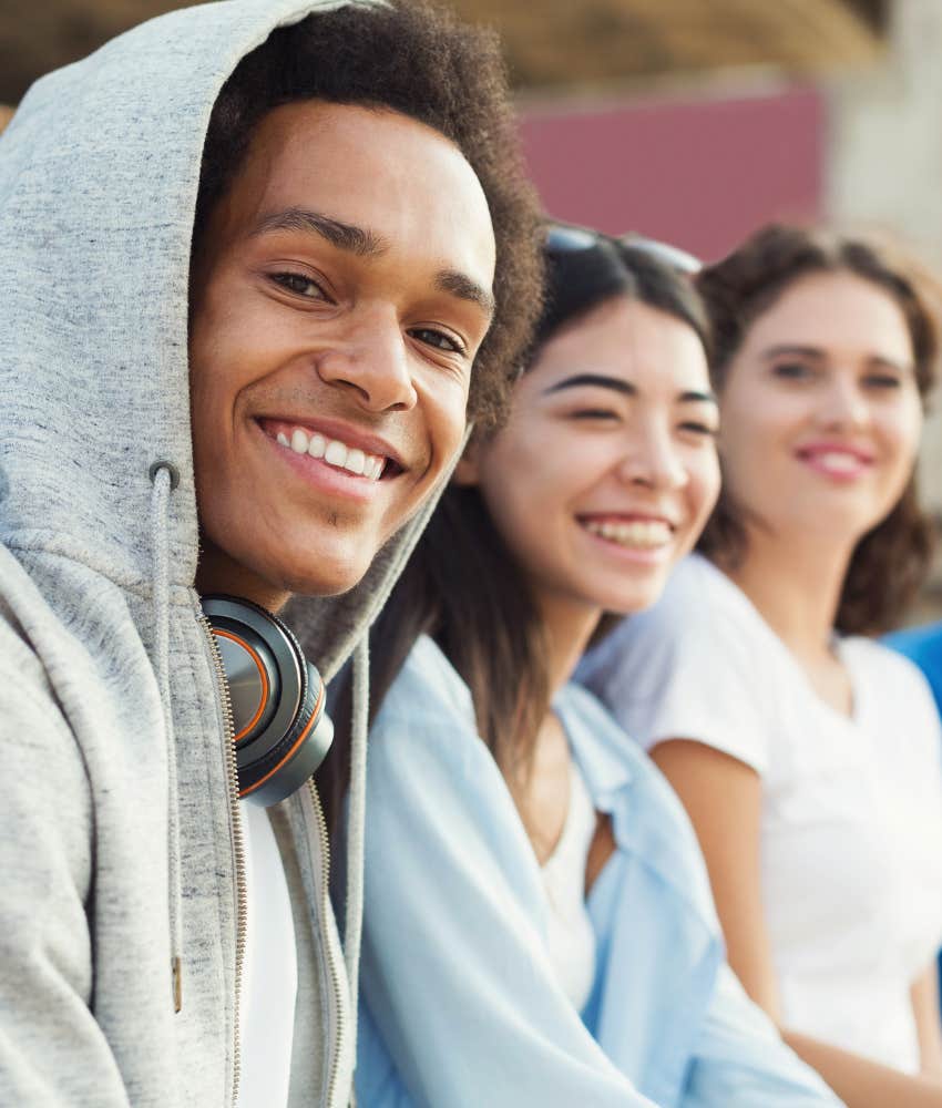 happy person with group of supportive friends