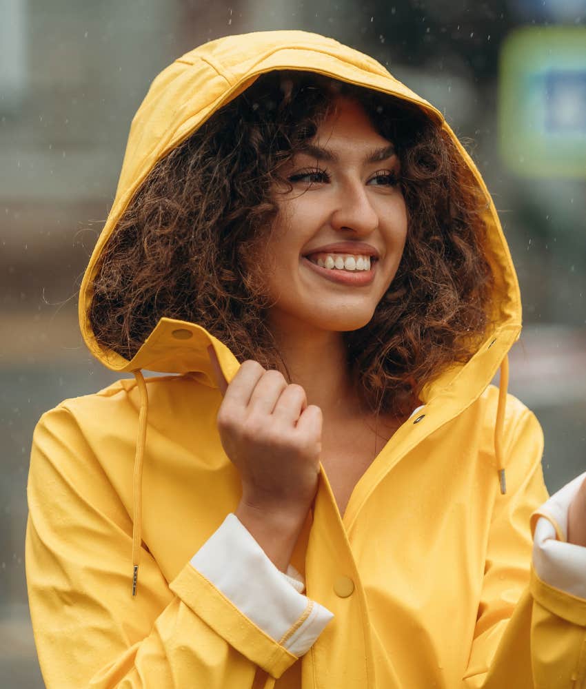 Happy person walks in the rain for a change