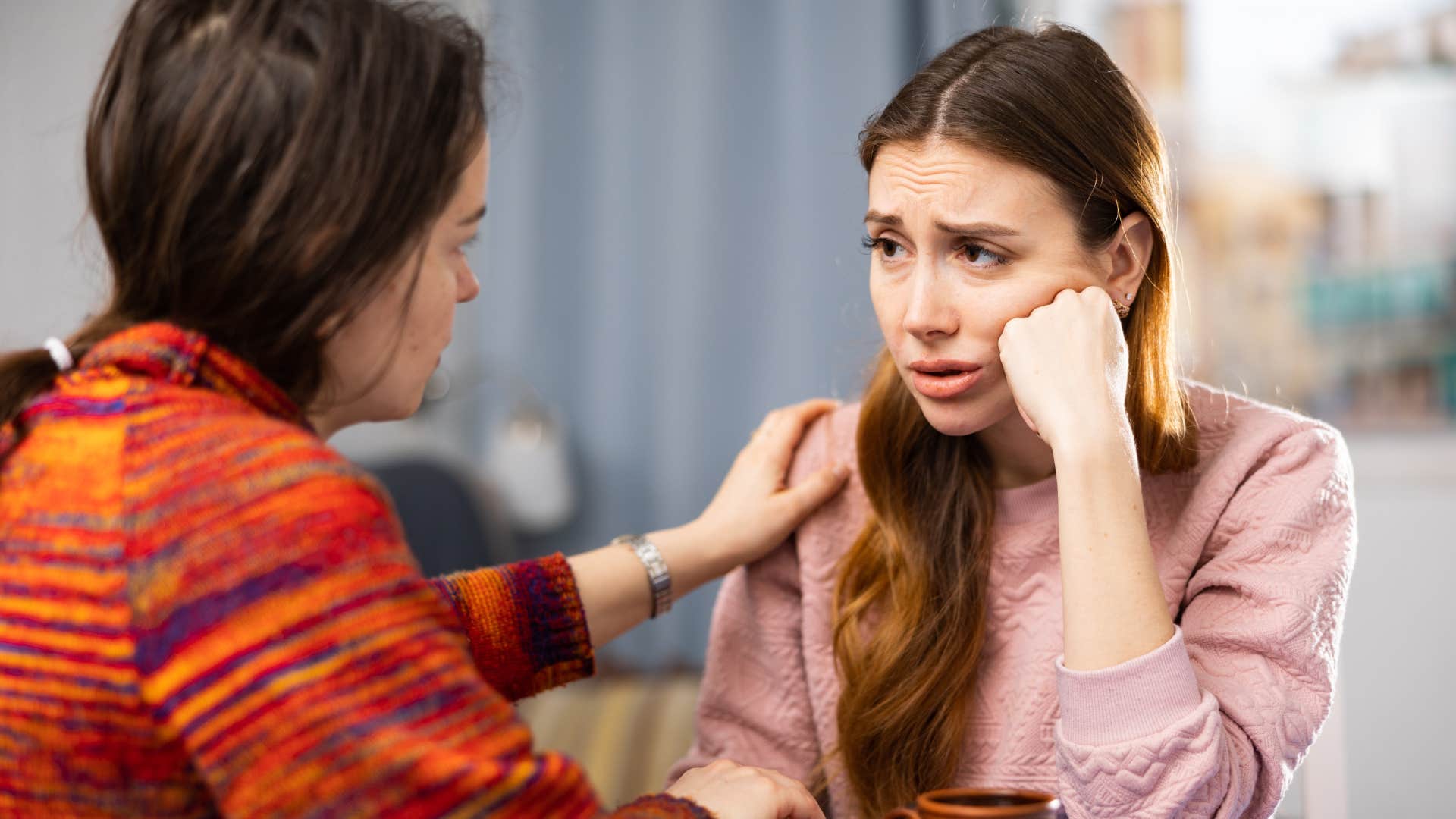 woman comforting friend who no longer blames people