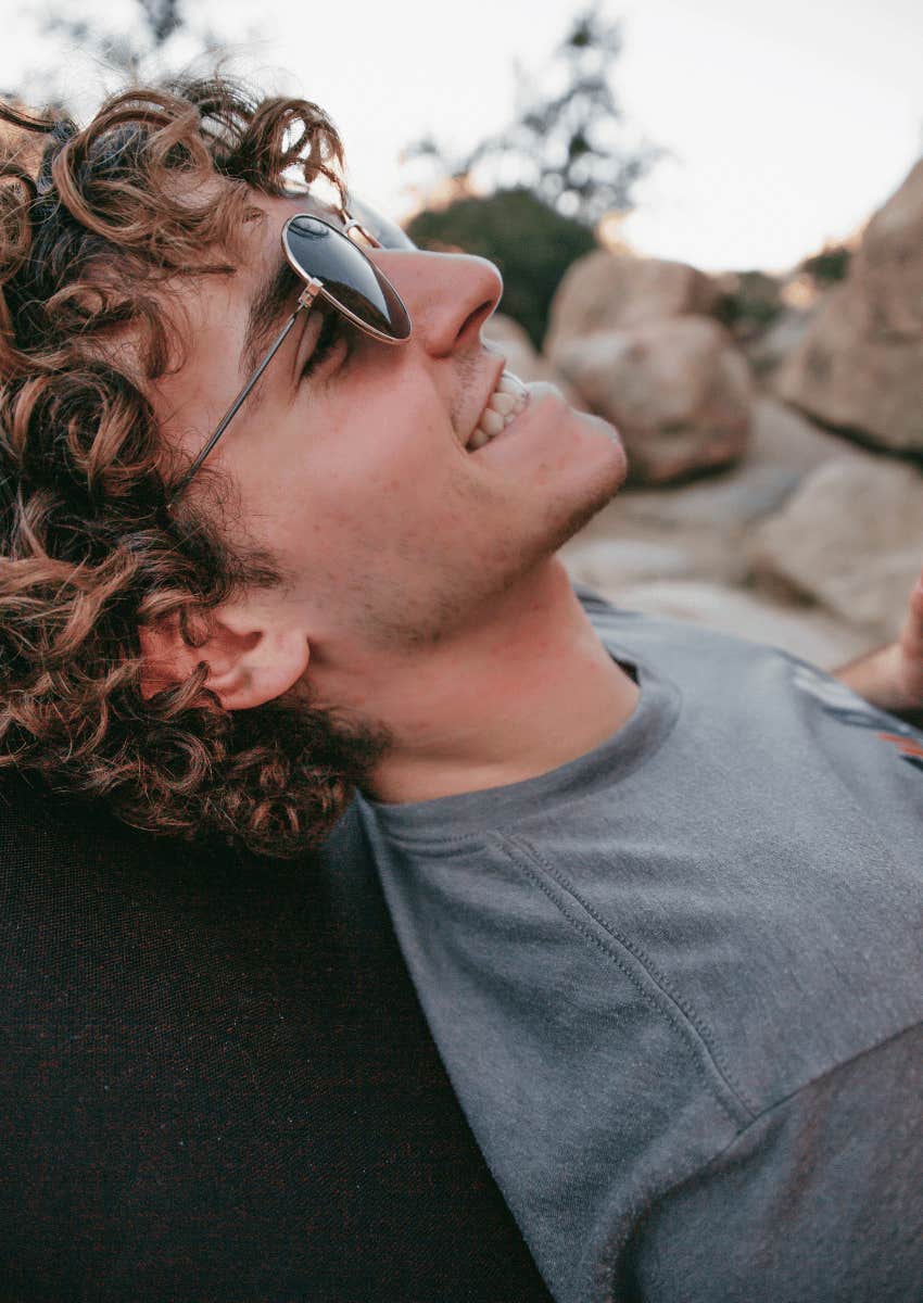 smiling man relaxing outdoors assuming his haters are his fans