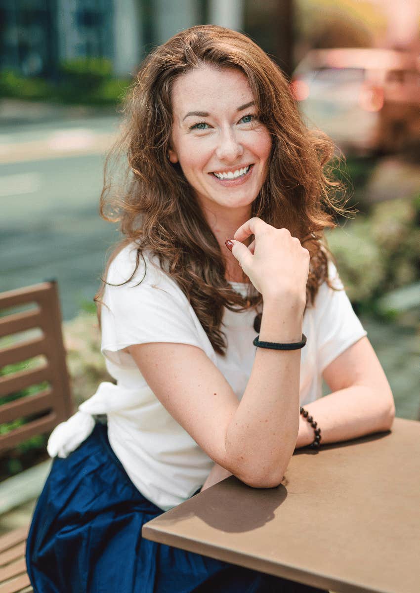 smiling empty nest woman sitting outdoors