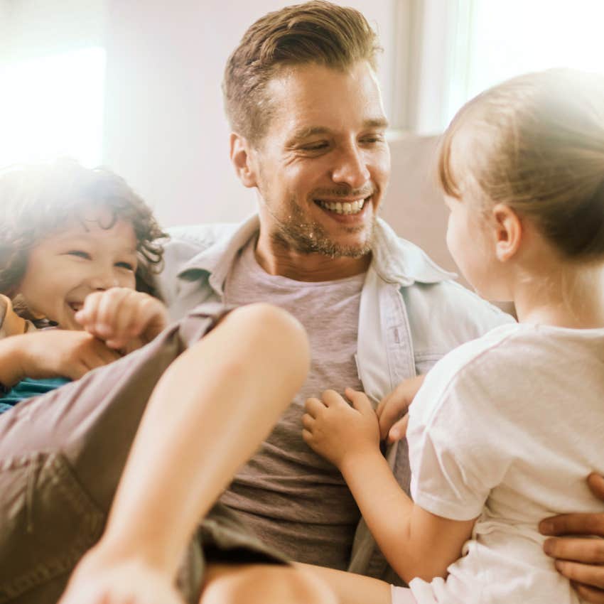 Man who prioritizes family time sitting with his kids