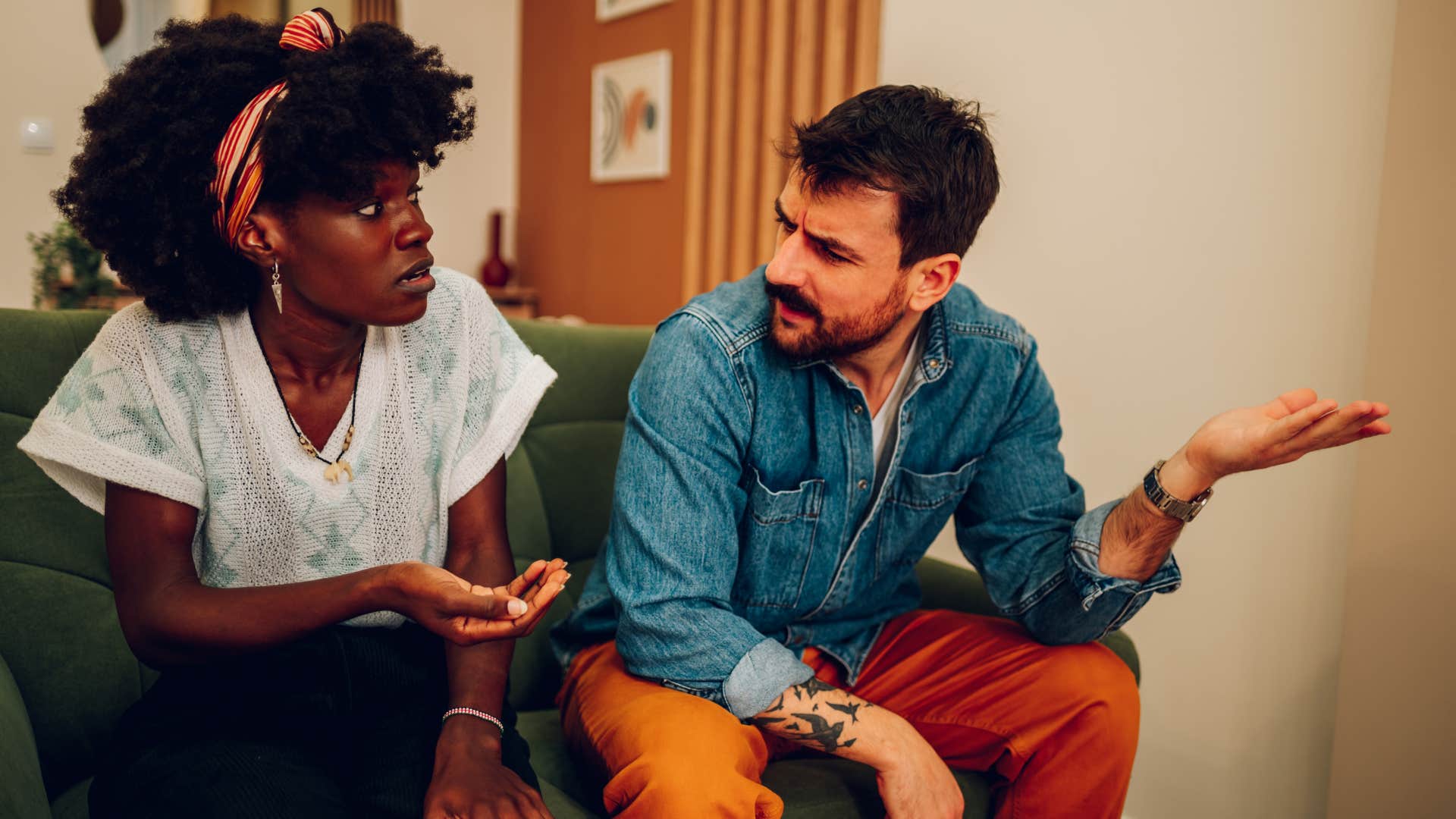 couple arguing in therapy as woman in white shirt says that's not what happened 