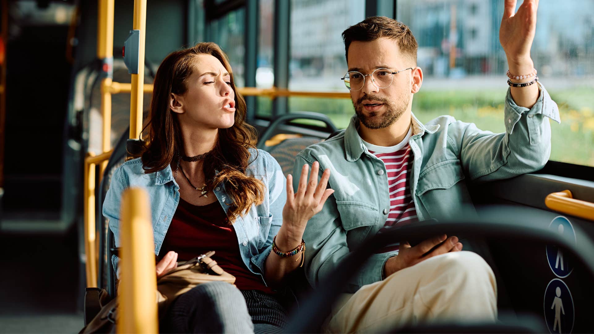 couple arguing on bus as man tells woman you're making a big deal out of nothing