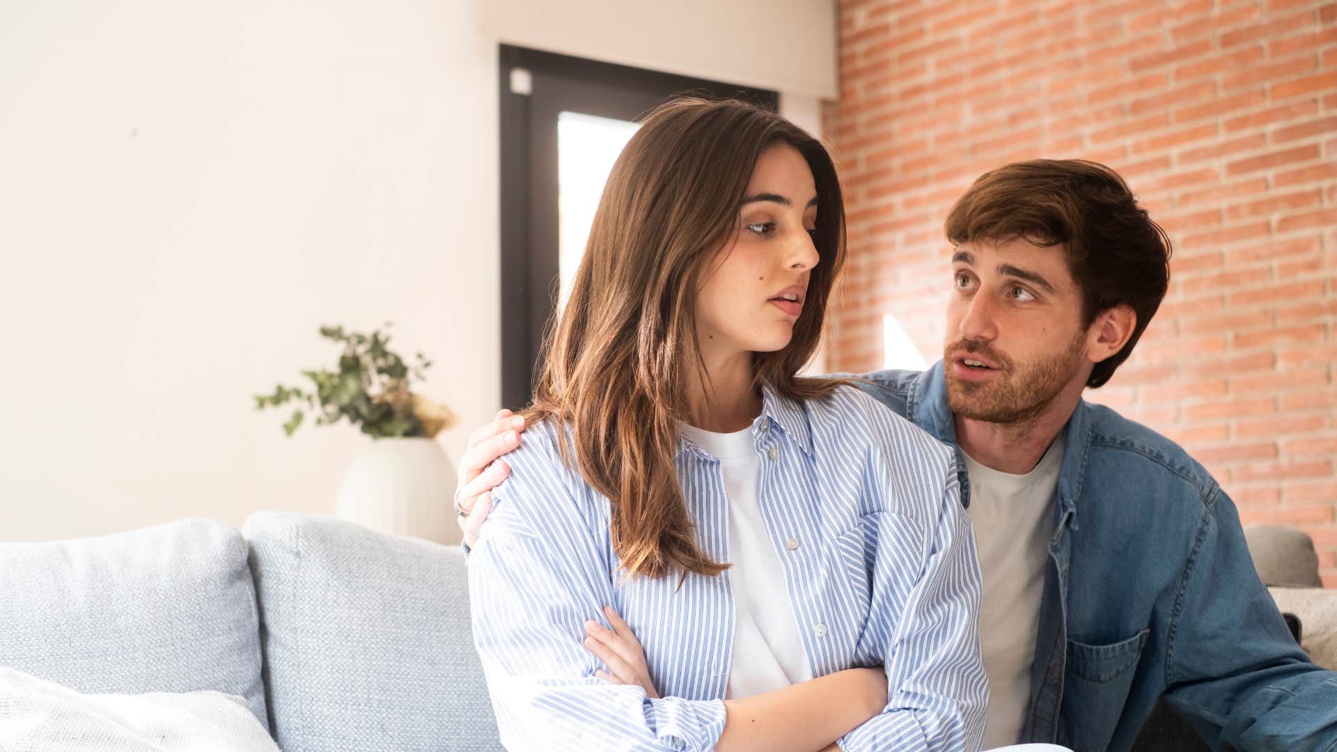 woman crossing arm as man tells her you always do this