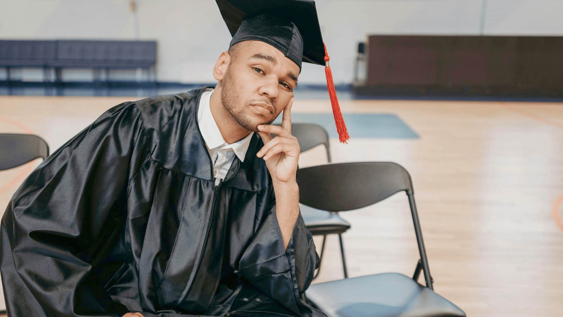stressed man in graduation cap not buying expensive diploma to retire earlier