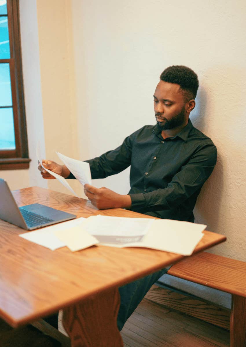 stressed man looking through his bills