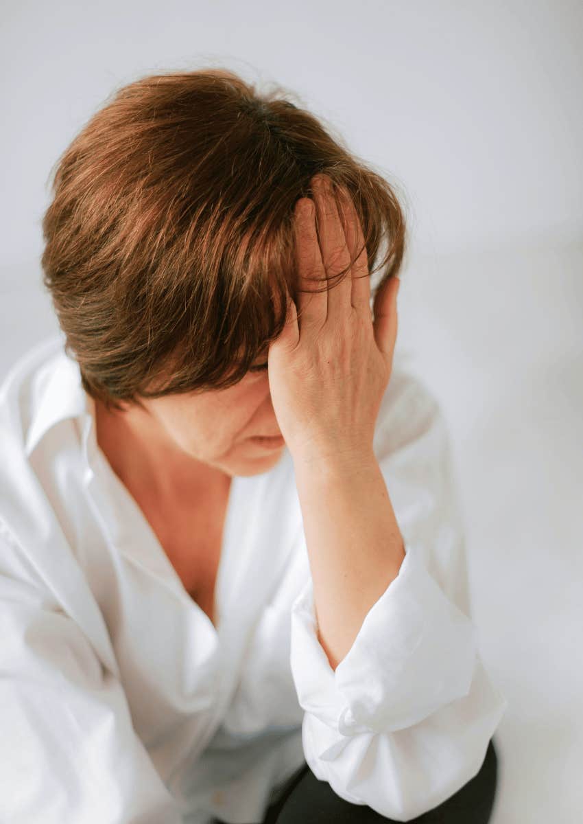 stressed woman covering her face with her palm