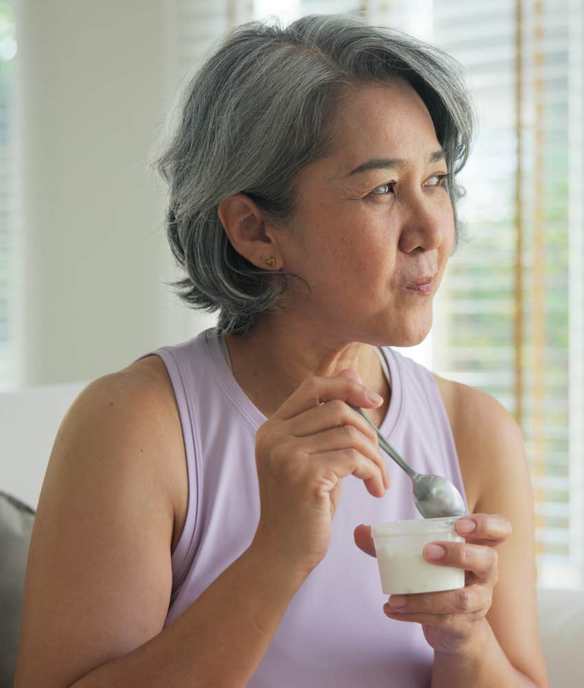 older person eats yogurt to ease digestion problem