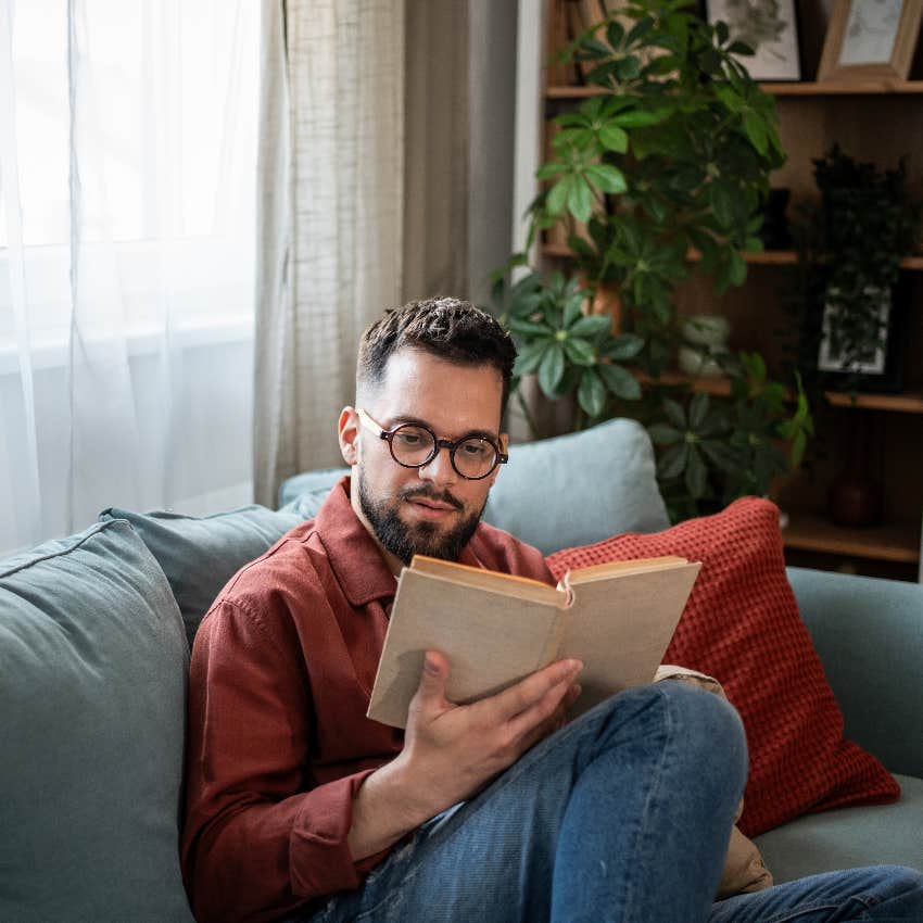 man reading book on couch thinks he's better than everyone else