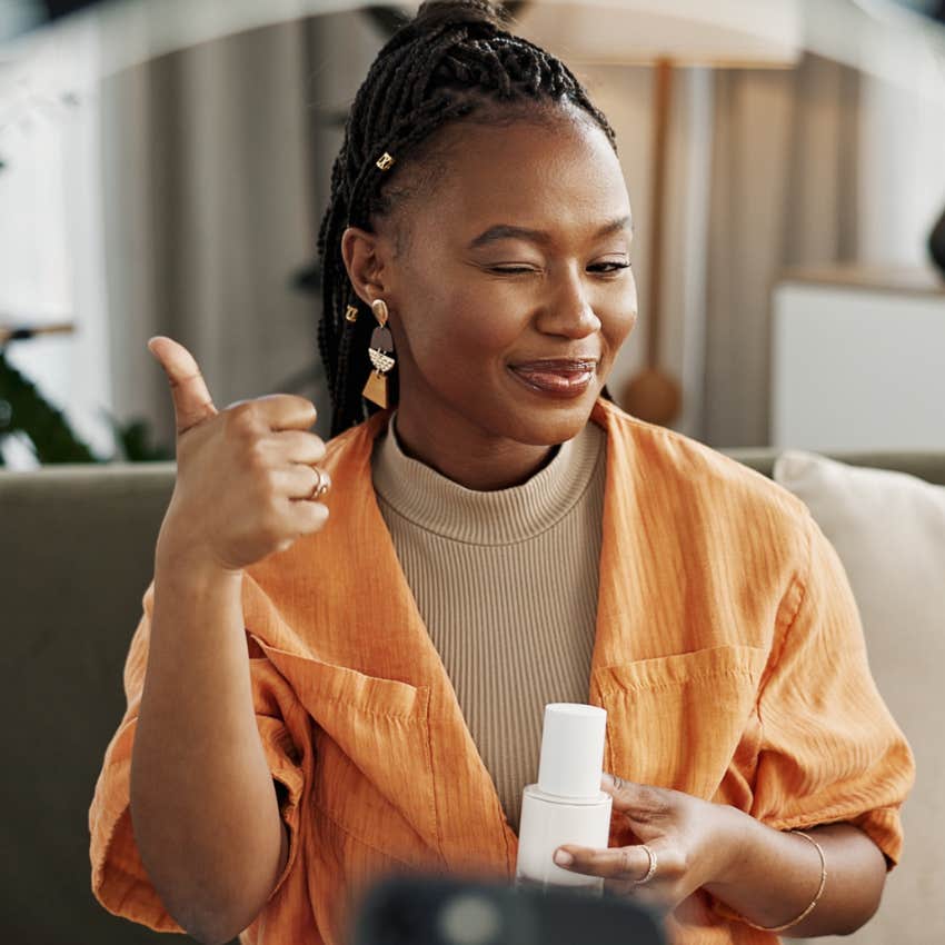 happy woman slowing down daily tasks while doing her skincare routine