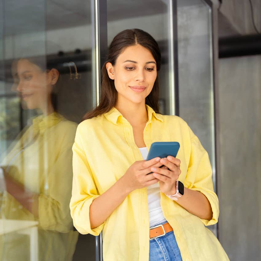 woman using her phone without realizing it's sharing her data in milliseconds