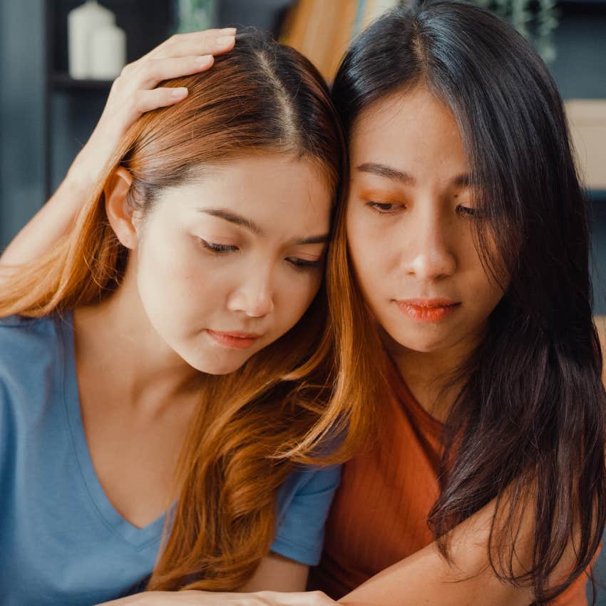 quiet woman whose calmness regulates others comforting her friend
