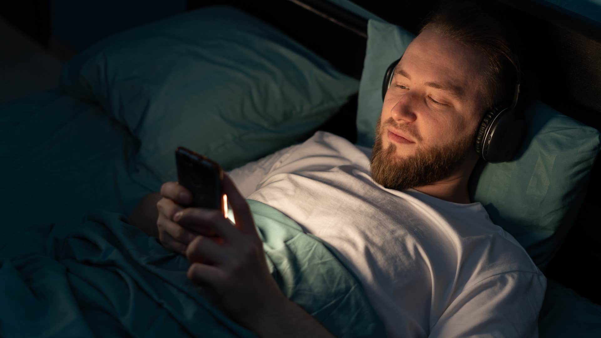 Man lying flat on his back in bed