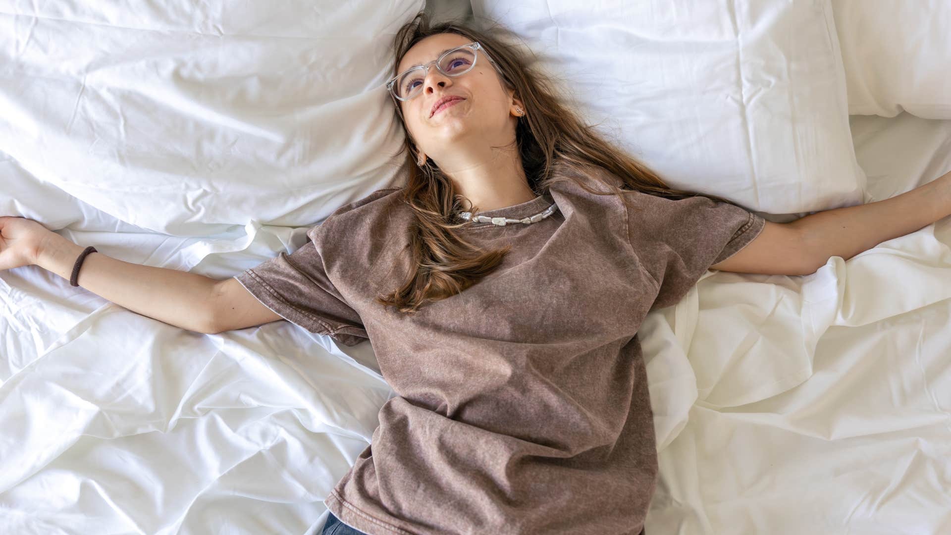 Woman sleeping in a starfish position