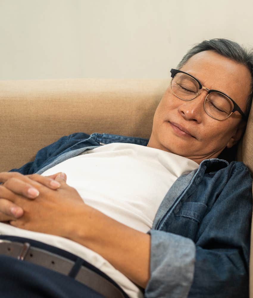 older person naps on couch