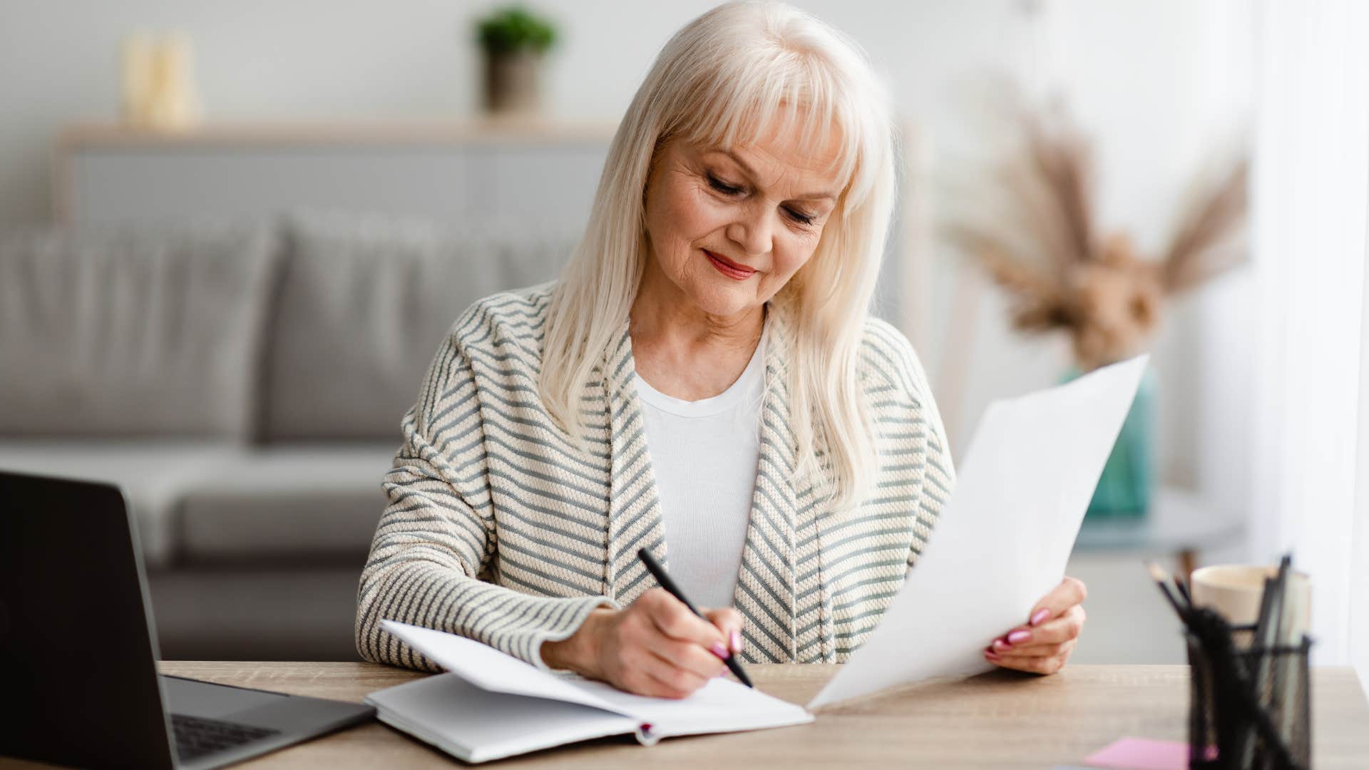 american woman writing things down in calendar