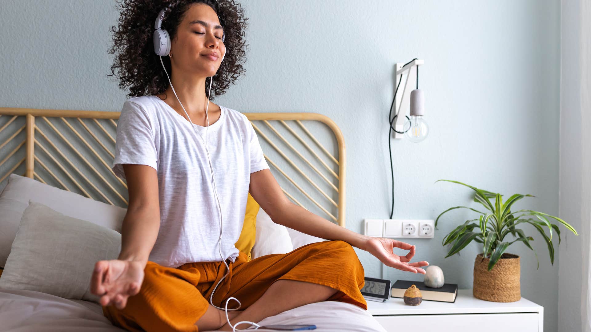 woman sitting on bed strongly attached to her morning routine