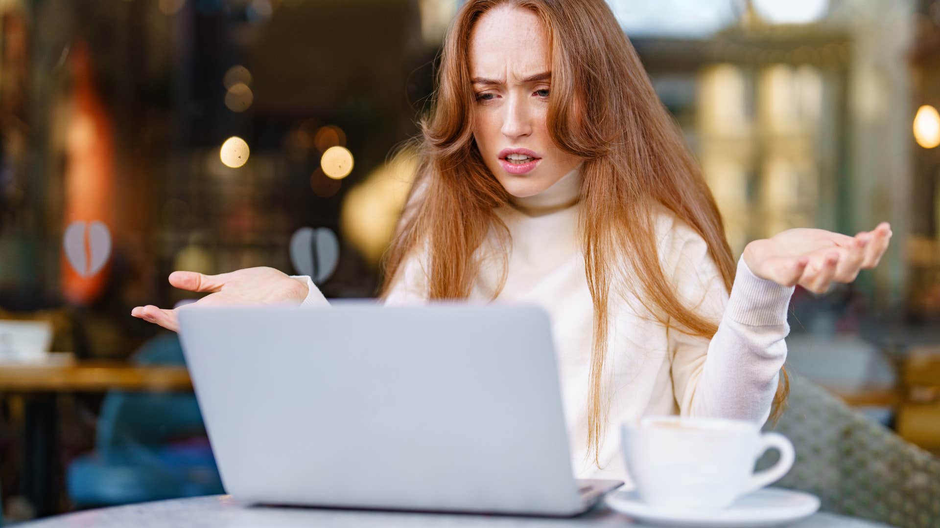 confused american woman looking at laptop tracking her package online