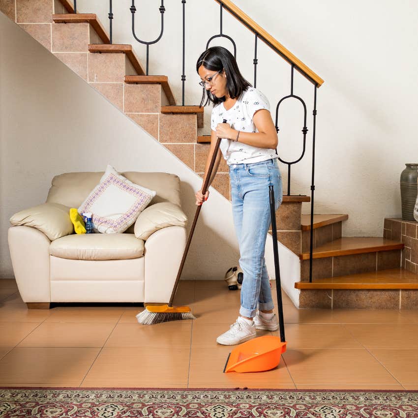 woman sweeping out negative energy on the first of the month
