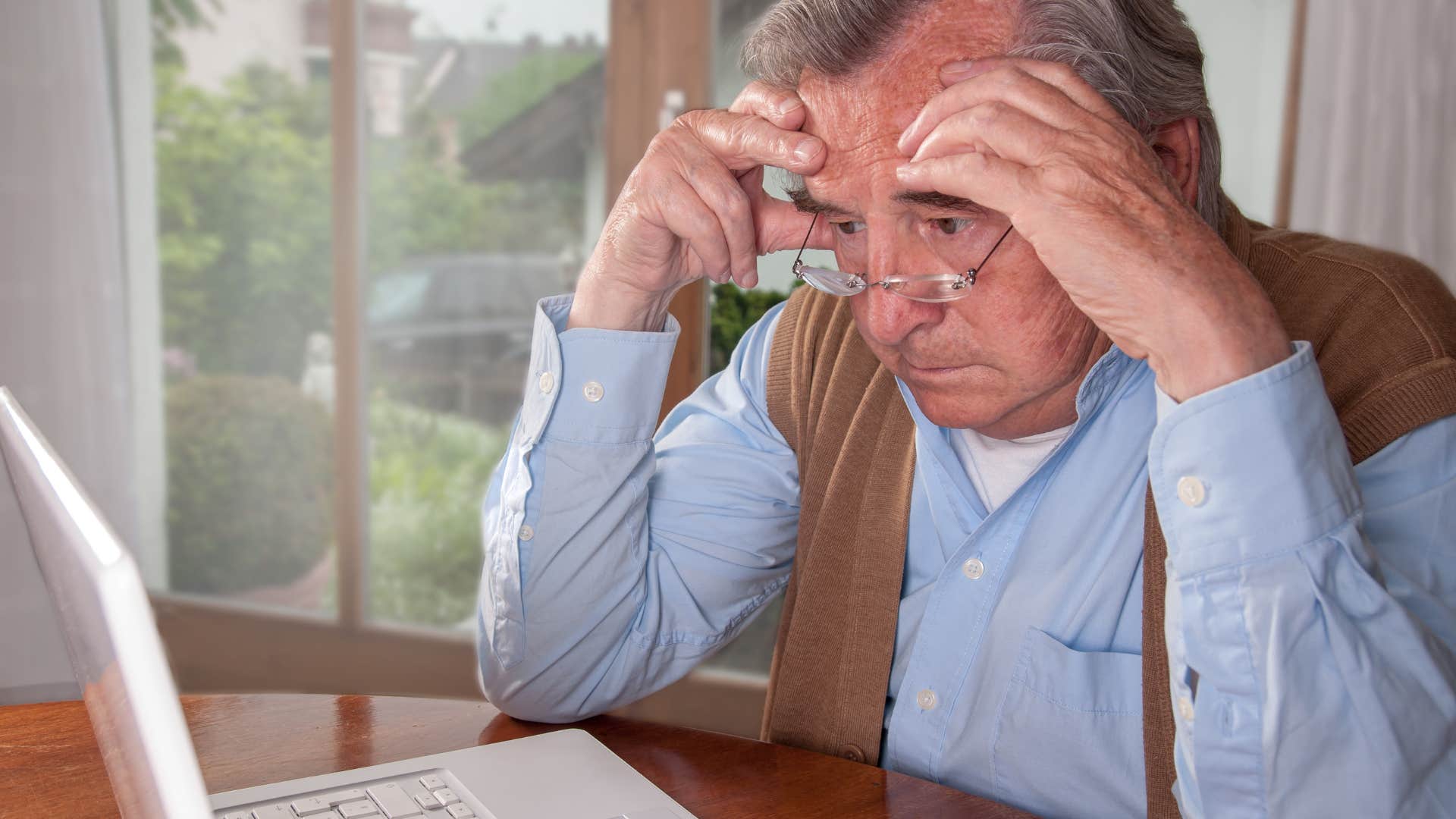 confused boomer man struggling with basic tech but refusing help