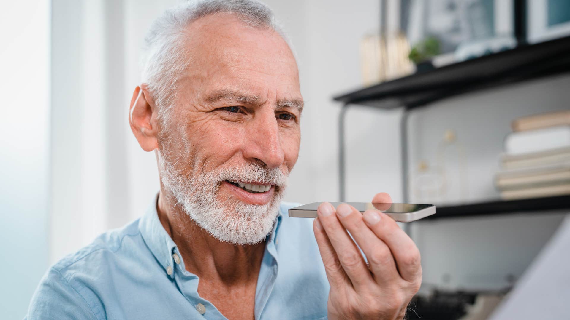 boomer man talking on speakerphone in public