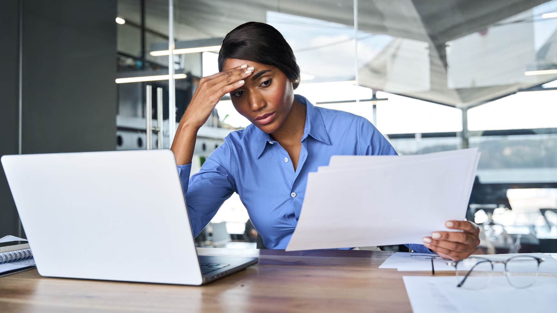 stressed young woman working in the office on the weekend