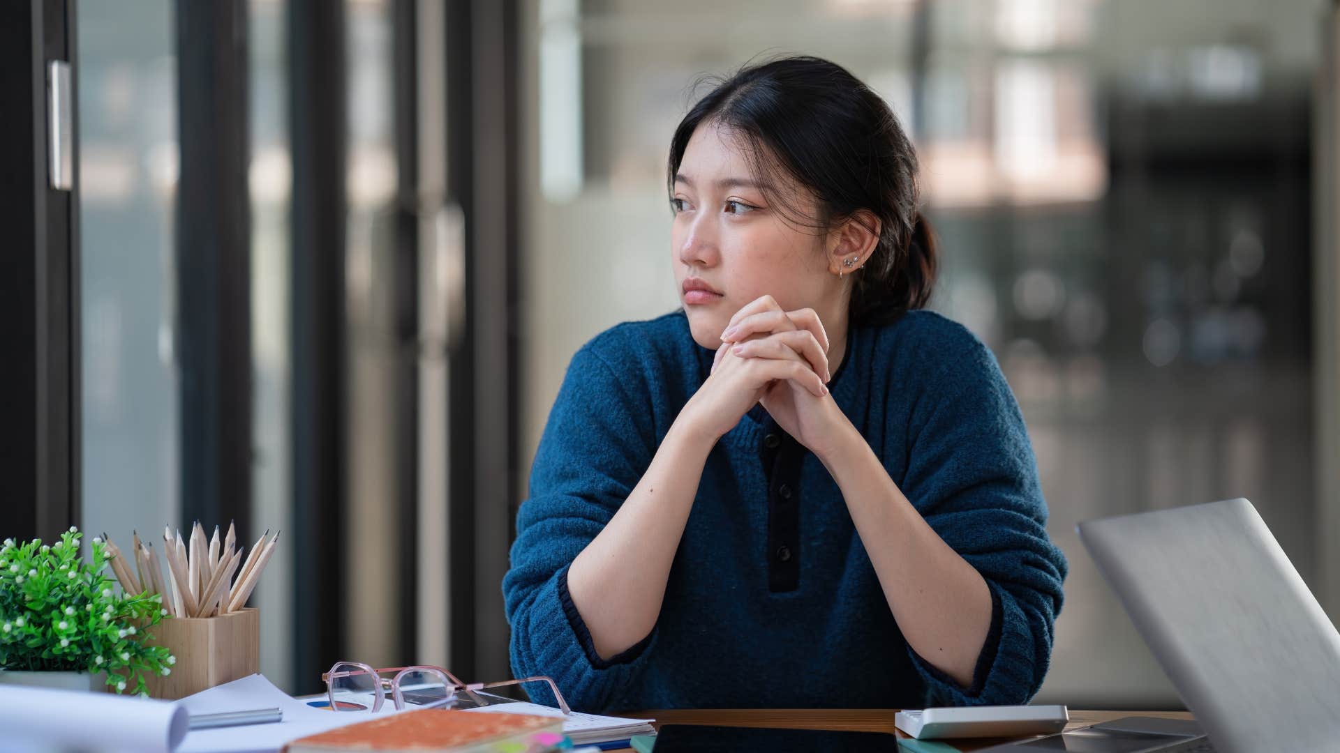 gen z woman annoyed about her in-person job that could be done remotely