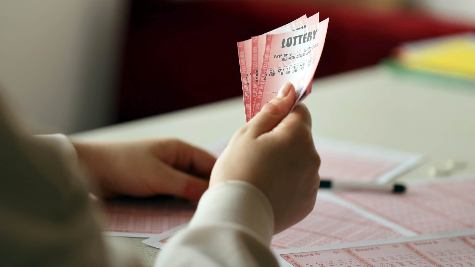 woman holding lottery tickets