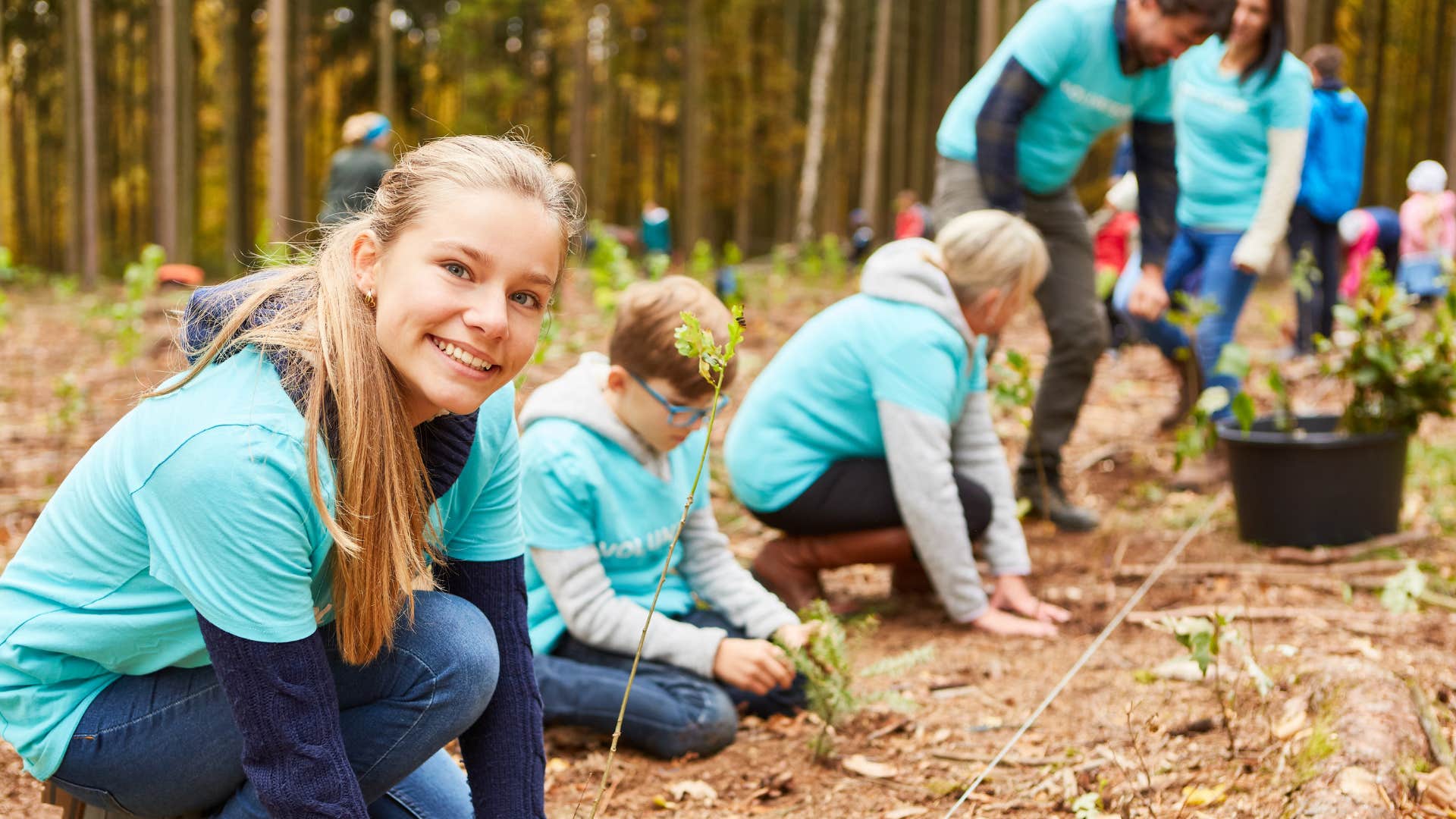 intergenerational group of volunteers plant trees