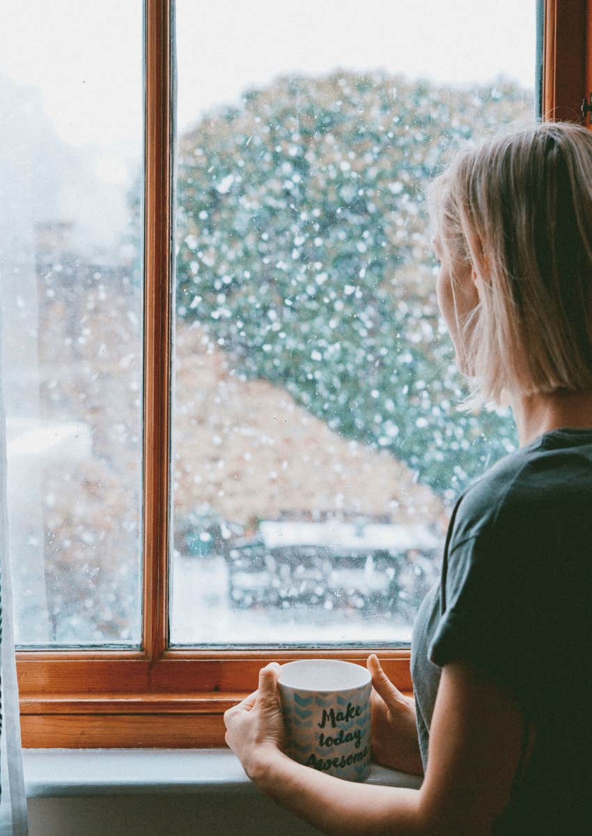 thoughtful woman looking out of window