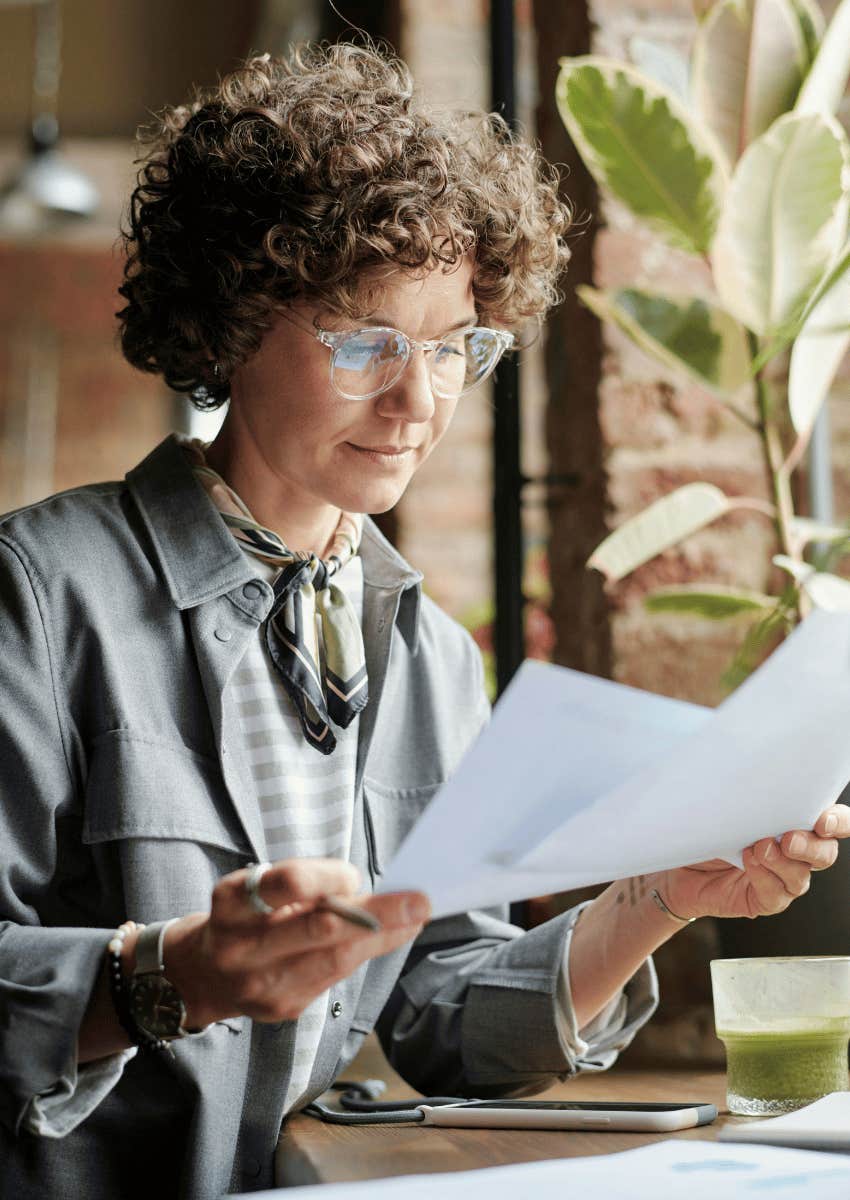thoughtful woman reviewing documents