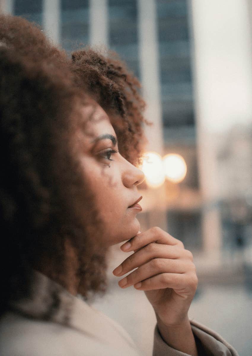 thoughtful young woman looking out intro the distance