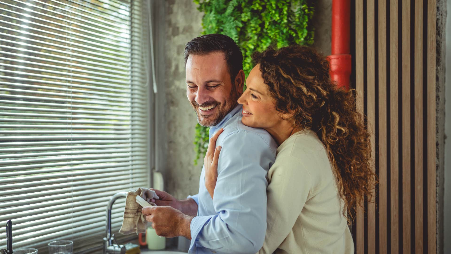 woman hugging husband from behind telling him i appreciate you