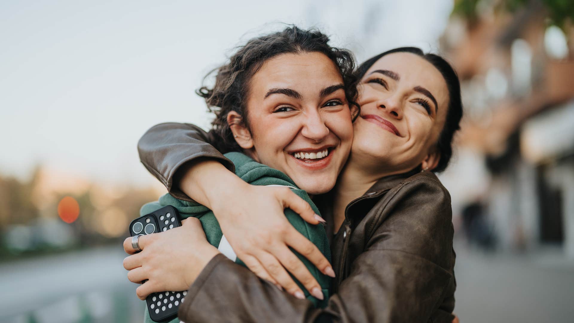 friends hugging for comfort smiling saying it's ok we all mess up