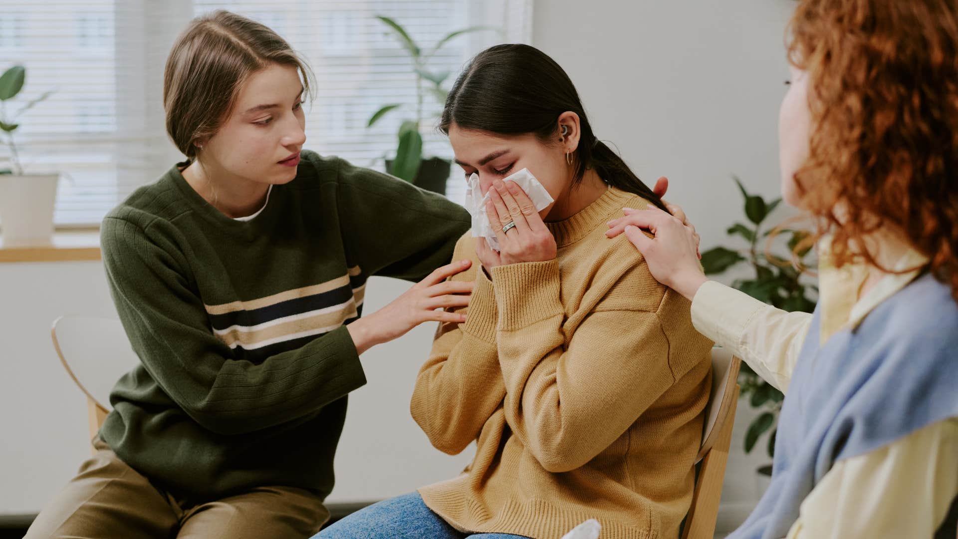 woman crying as friends tell her take your time