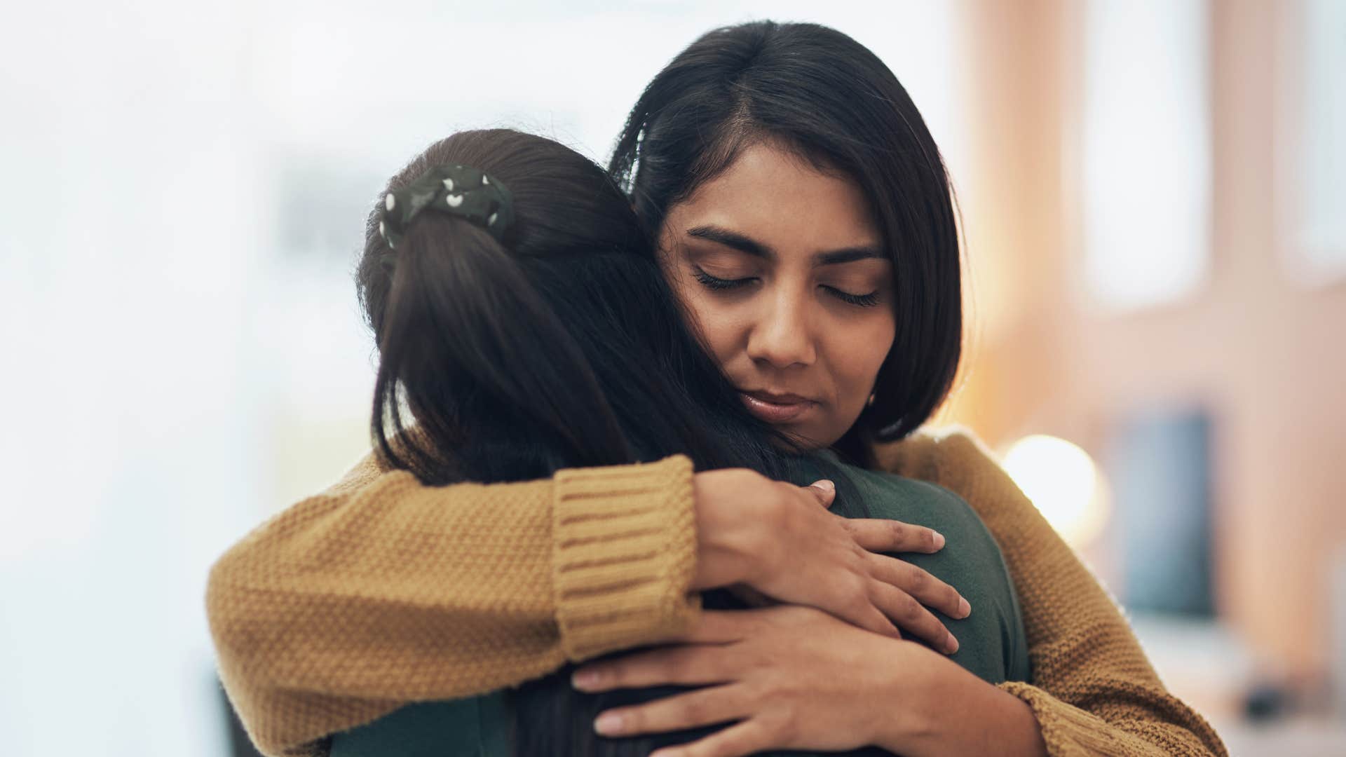 woman hugging friend telling her must have been really hard for you