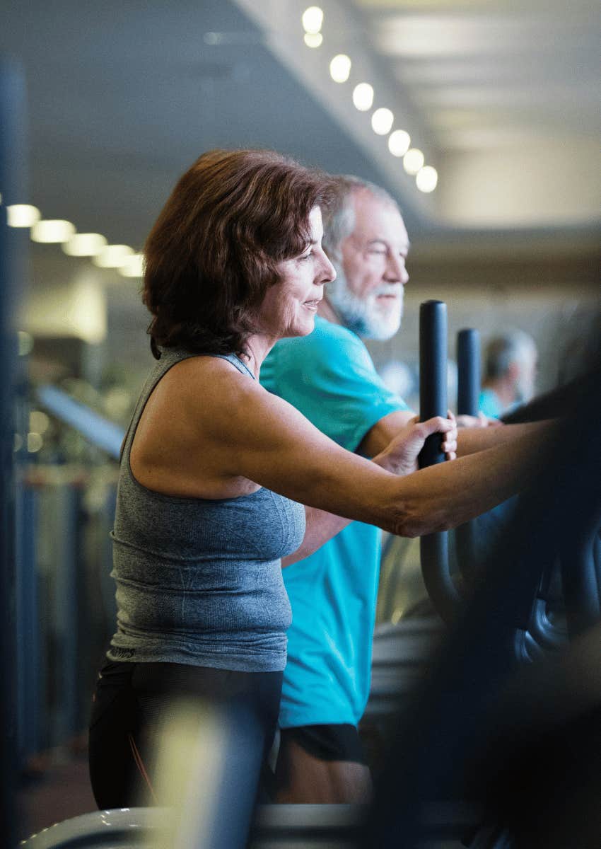 two middle age people working out talking at gym