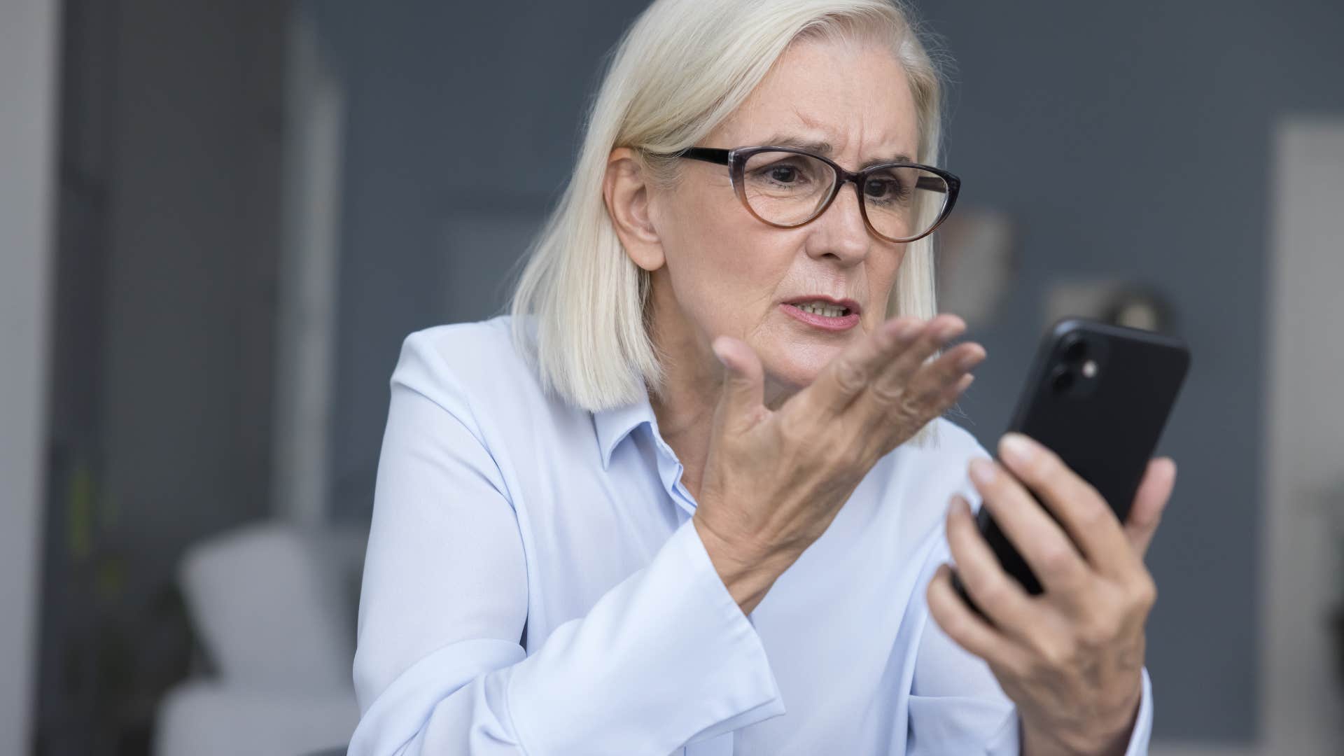 Woman getting serious feedback in a public email at work.