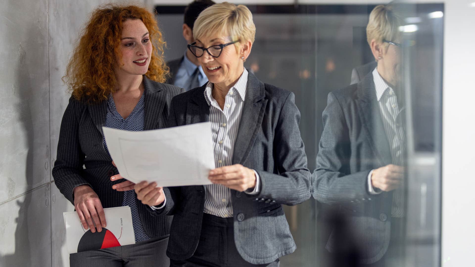 Woman watching someone else be praised for her idea at work.