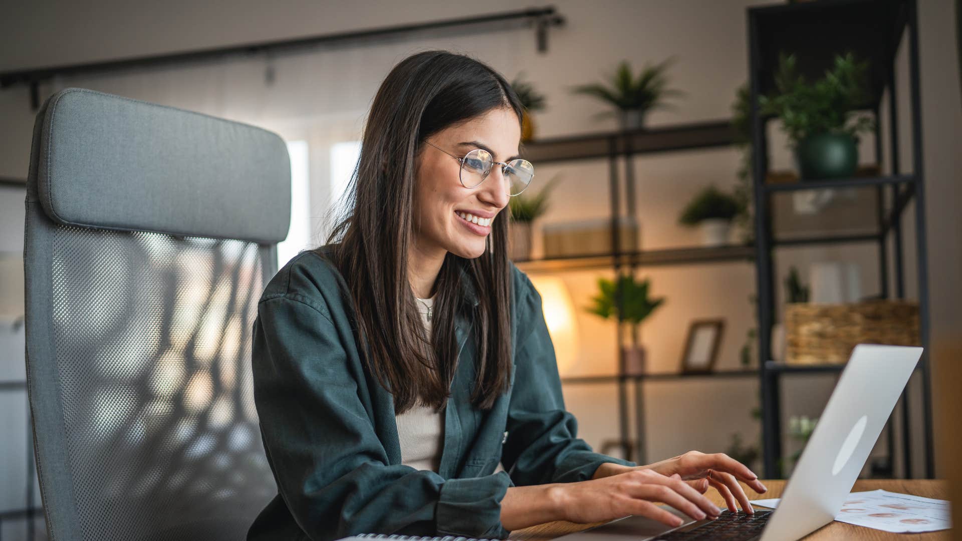 woman typing on laptop in green shirt as she thinks i don't have time to think about that
