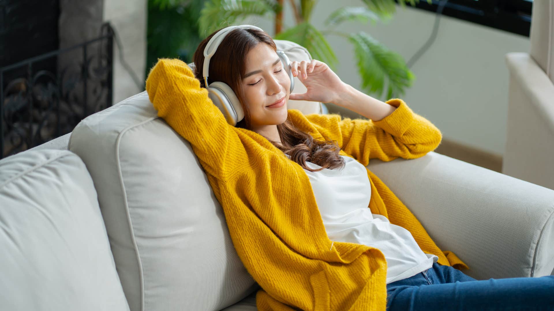 woman relaxing on couch with headphones as she thinks i don't need to explain myself